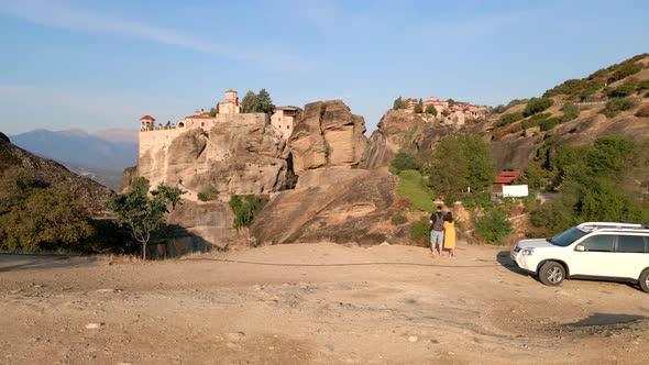 Couple Traveler Near Suv Car Looking at Templates at Mountains Peak