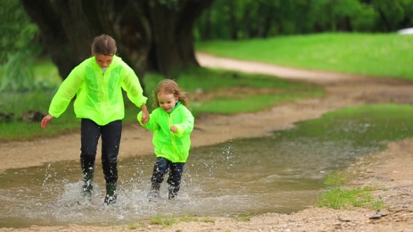 Cute Kids Running In Huge Puddle