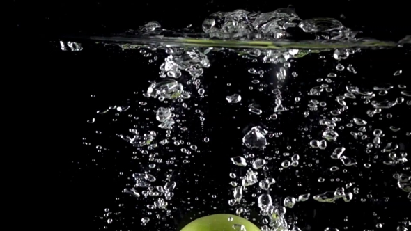 Green Apples Fall Down In Water Against Black Background alt
