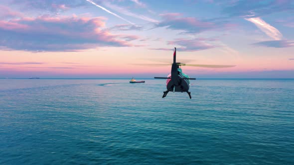 Helicopter Flying Over The Sea