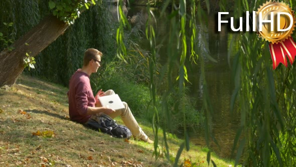 Man With Laptop is Sitting at the Slope Under alt