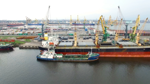 Aerial view of cargo ship in the port with an open hold, awaiting loadin in Saint-Petersburg, Russia