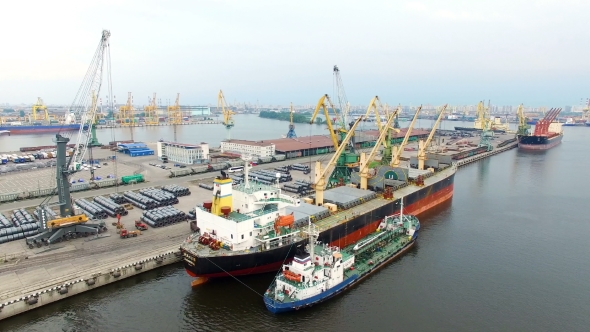 aerial view of cargo ship in the port which is loaded in the holds