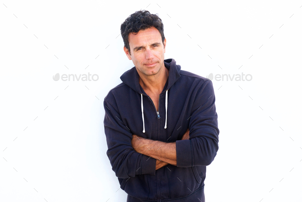 Rugged handsome middle aged man standing with arms crossed