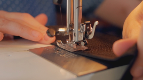 Sewing Machine is Stitching Black Fabric 