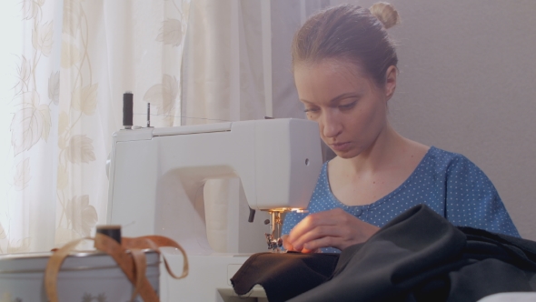Caucasian Woman Is Stitching Black Fabric