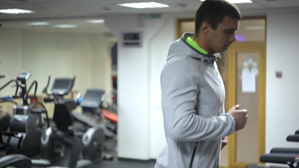 Athlete In a Hoodie, Engage Is On a Treadmill In Gym.