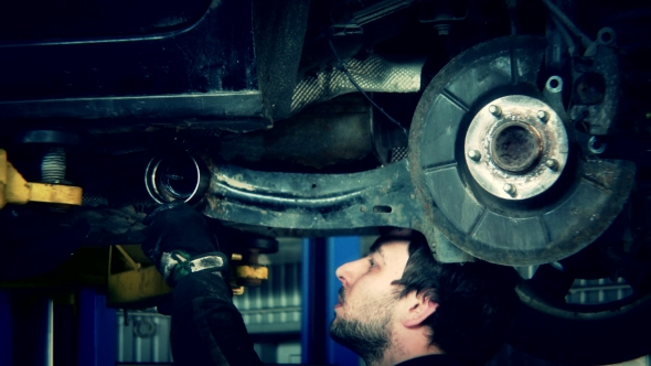 Mechanic Renew Brake System Of a Vehicle On a Car Lift