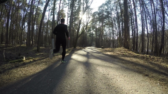 Man Run With Sportswear  Around The Forest Path. 