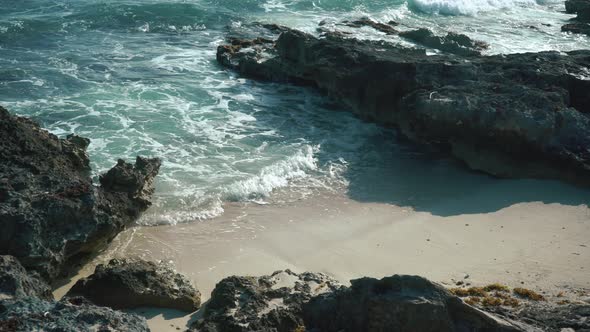 Breaking Sea Waves Between Rocks in Isla Mujeres Mexico