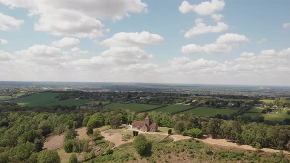 Aerial drone shot of church in countryside track back alt