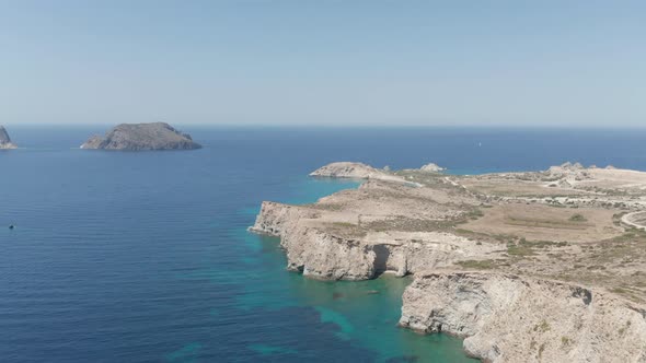 Wide Aerial Establishing Shot of Greek Island Milos in Summer with Turquoise Blue Aegean Sea alt