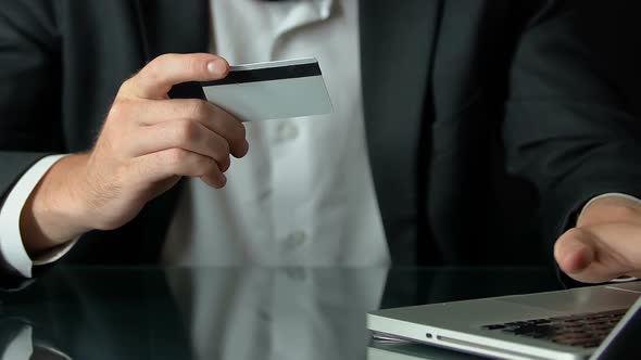 Male in Suit Inserting Card Number on Laptop Pc, Shopping Online, Transactions alt