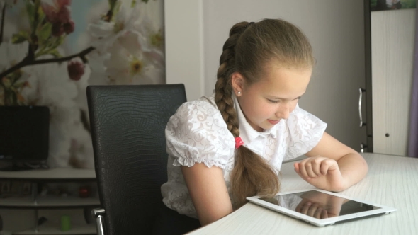 Primary Schoolgirl Using a Digital Tablet Computer