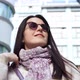 Fashion Beautiful Smiling Woman in Scarf and Sunglasses Surrounded By Modern Building in Megapolis
