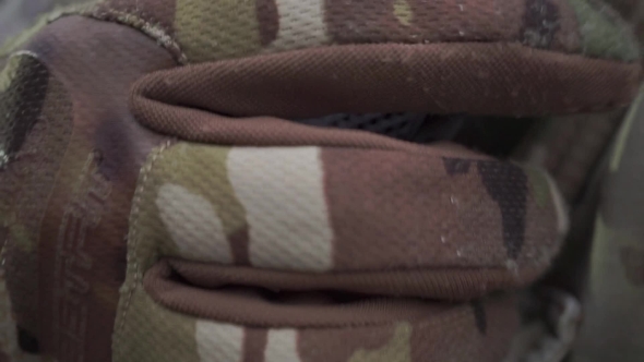 Unrecognizable Soldier In a Camouflage Talking On Walkie-talkie alt