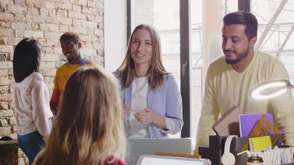 Diverse Creative Colleagues Speaking in Designer Office