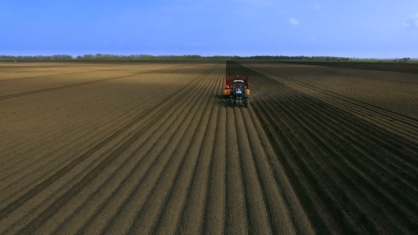 Planting Potatoes With Tractor.The Planter On The Field.The Introduction Of Fungicides.Aerial View 2 alt