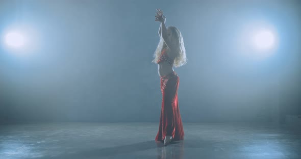 Girl is in a Beautiful Oriental Costume Preparing to Start Dancing alt