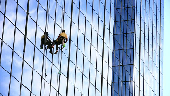 Man Cleaning Windows of Office Building