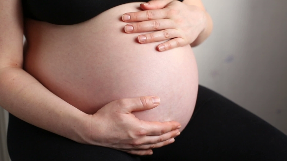 A Pregnant Woman Holding Belly