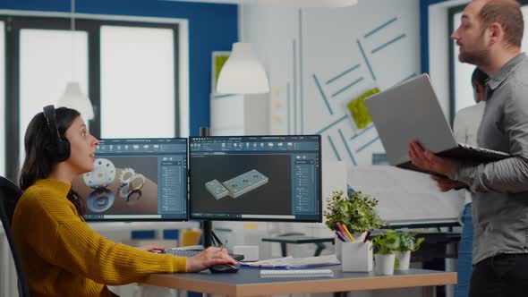 Man Project Supervisor Holding Laptop and Talking with Woman Engineer alt