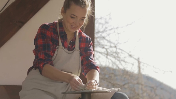 Young Woman In Checkered Shirt Practices In Artistic Molding