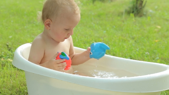 Cute Toddler Having a Bath in Garden