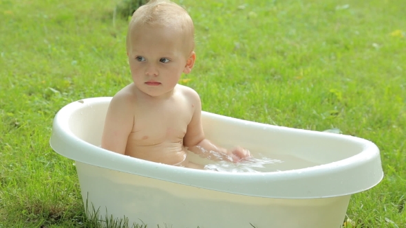 Cute Toddler Having a Bath In Garden