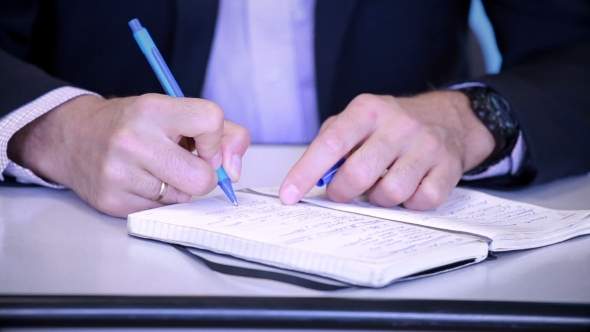 Hands Male Businessman, Making Notes in the Phone Book