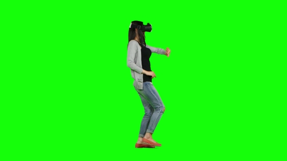 Woman In a Virtual Reality Mask Walking. Green Screen alt