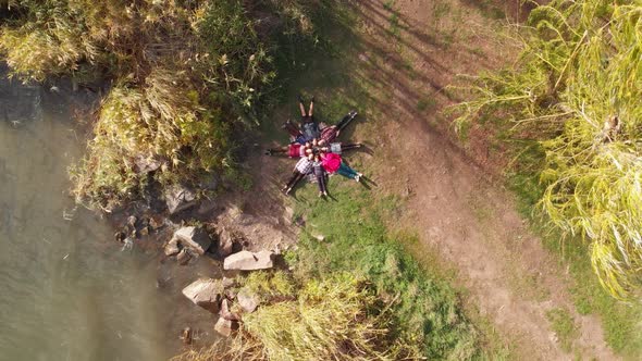 Aerial Top Down Drone View of Group People Lying on Grass Like Star Friends Have Good Time Together alt