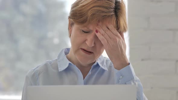 Headache Tense Old Woman Working on Laptop alt
