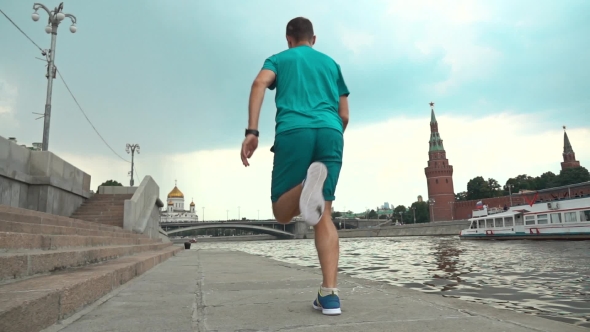 Athletic Male Running Against Moscow Kremlin. Super  Steadicam Video 240 Fps alt