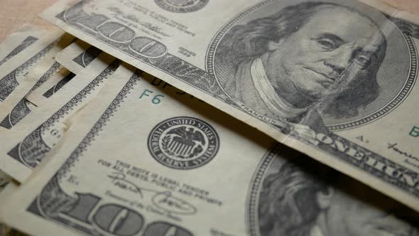 Hundred Dollar Bills Fall on the Table