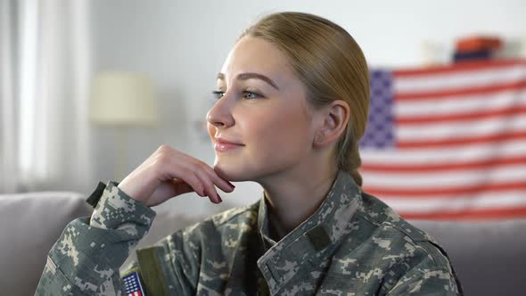 Smiling American Female Soldier in Military Uniform With US Flag on Background alt