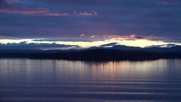 Sea cruise ship along the coast of Alaska. Colorful sunset in the mountains of Alaska. alt