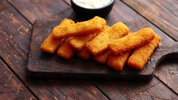 Pile of Golden Fried Fish Fingers with White Garlic Sauce alt