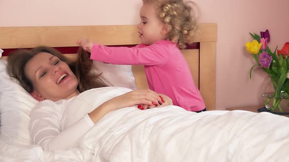Toddler Daughter Awake Sleeping Mother Mom in Bed