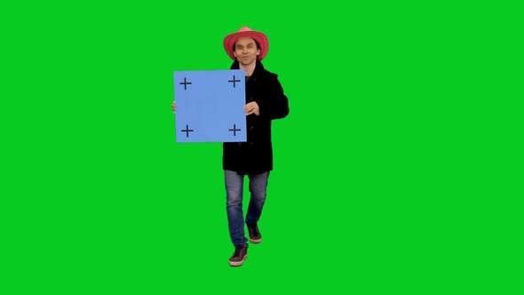 Stylish Man With Blank Mockup Board Walking And Speaking on Green Screen