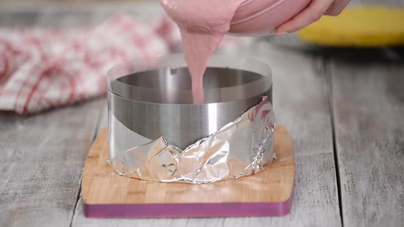 Pouring Berry Mousse Into Cooking Form. Step By Step French Mousse Cake Making Process. alt