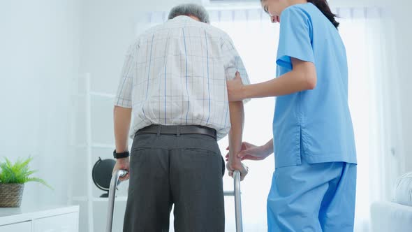 Asian senior elderly man patient doing physical therapy with caregiver. alt