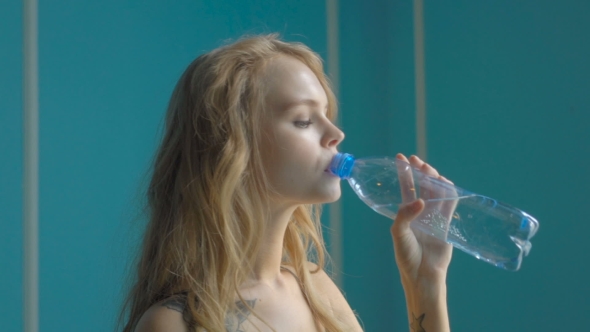 Young Woman Drinking Mineral Water Bottle