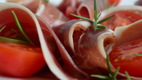 Jamon with tomatoes and rosemary. alt