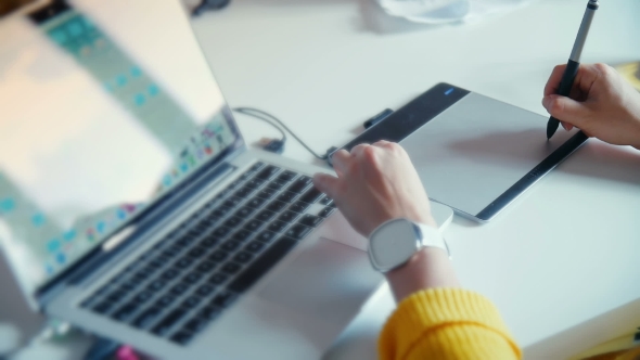 Graphic Designer Working With Drawing Tablet With Pen On White Surface alt