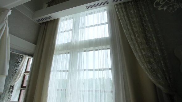 Auto-closing Curtains In The Apartment With a Large Window