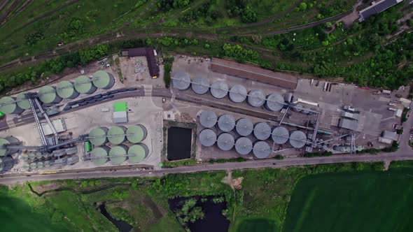 Commercial Grain Or Seed Silos In Sunny Spring Rural Landscape alt