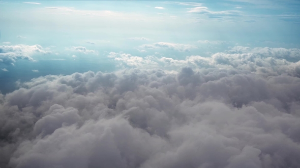 Airplane Flying Above Clouds
