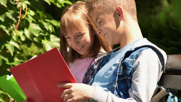 Boy And Girl Reading Book