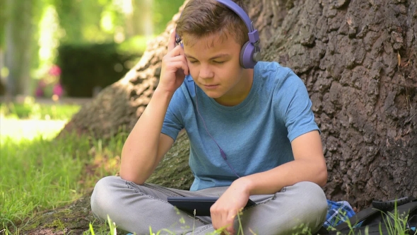 Boy With Tablet At Park